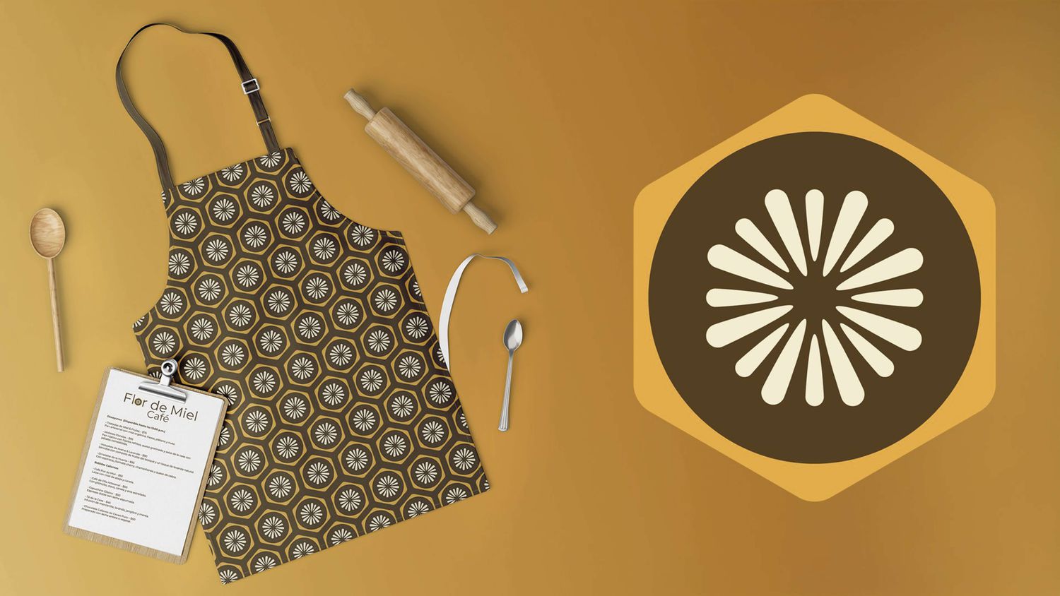 Mandil con el patrón floral, utensilios de cocina y carta impresa con la marca.